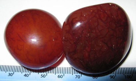 Polished carnelian/sard pebbles. Scale is in millimeters.